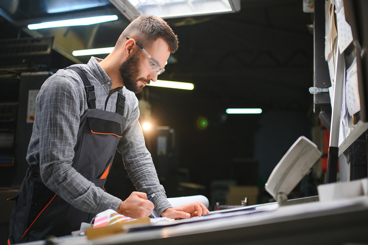 Man working on a printing machine
